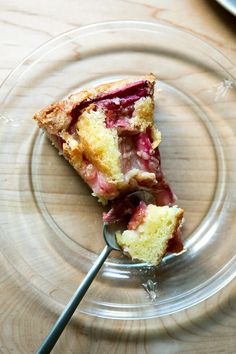 a piece of cake on a glass plate with a spoon