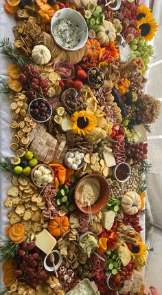 a table with many different types of food on it, including crackers and nuts