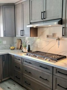 a stove top oven sitting inside of a kitchen next to wooden cabinets and counter tops