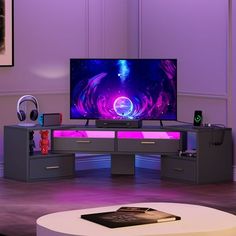 a large flat screen tv sitting on top of a wooden table in a living room