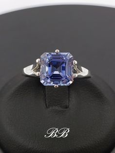 Made to order.  Please allow up to 3 weeks for production of your ring. This listing is for a 925 unplated sterling silver ring with a high quality lab created ceylon blue sapphire gemstone. Gem Type: Lab Created Sapphire Shape: Asscher Cut Size: 8mm Weight: 2.5 carats approximately Quality: AAA Hardness: 9 Mohs Available in the following Metal Options (all are unplated metals) 925 Sterling Silver 10kt White Gold (non-rhodium plated) 10kt Yellow Gold 14kt White Gold (non-rhodium plated) 14kt Yellow Gold 14kt Rose Gold Did you know lab-created sapphires are equivalent to natural sapphires? Lab grown sapphires have the same chemical composition as natural sapphires. They have the same refractive index (sparkle), specific gravity etc. They are made of corundum, the same thing mother nature ma Octagon Sterling Silver Ring For Formal Occasions, Asscher Cut Sapphire Ring In Sterling Silver, Formal Tanzanite Ring With Asscher Cut, Lab-created Sapphire Jewelry With Asscher Cut, Classic Tanzanite Jewelry For Promise Ring, Asscher Cut Tanzanite Fine Jewelry, Platinum Sapphire Jewelry With Asscher Cut, Sapphire Asscher Cut Platinum Jewelry, Asscher Cut Sapphire Platinum Jewelry