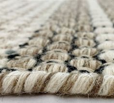 a close up view of a rug with black and white designs on it's edges