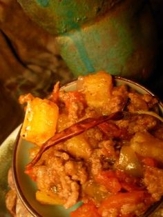 a bowl filled with food sitting on top of a table