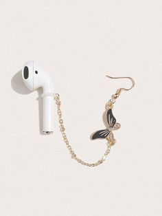 an earphone attached to a chain with a butterfly charm on it's side