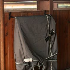 the back end of a horse's stall with a blanket on it