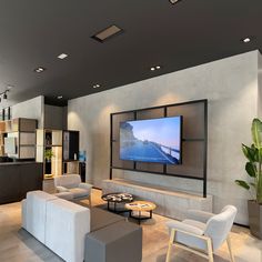 a large flat screen tv mounted to the side of a wall in a living room