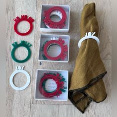 three napkin rings, one ring holder and two napkin rings in boxes on the floor