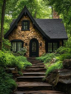 a stone house in the woods with steps leading up to it's front door