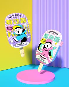 two ping pong paddles with cartoon characters on them in front of a colorful wall