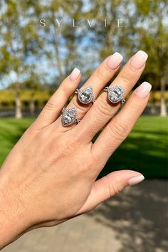 a woman's hand with two rings on it