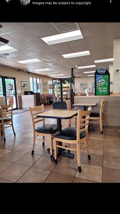 the inside of a restaurant with tables, chairs and counter tops in place for customers to sit at