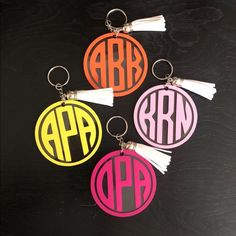 four key chains with tassels and the letters arr in different colors on them