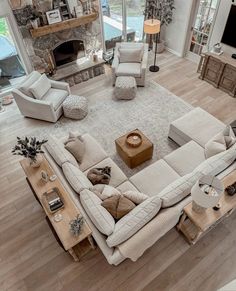 an aerial view of a living room with couches, chairs and a fire place