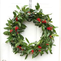 a white door with a wreath hanging on it