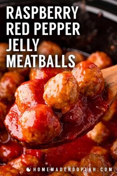 a wooden spoon filled with meatballs and ketchup in a slow cooker