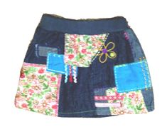 a skirt made out of old jeans with flowers on the front and blue trims