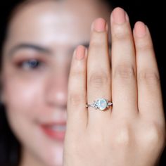 a close up of a person holding a ring