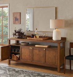 a living room with a large mirror and wooden furniture