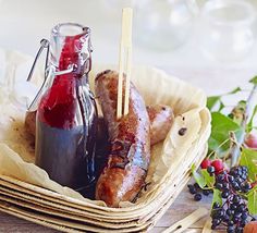 sausages, fruit and ketchup in a basket on a table