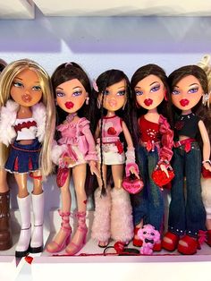 a group of dolls that are standing next to each other