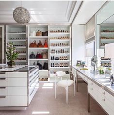 a room filled with lots of white furniture and shelves full of different types of shoes