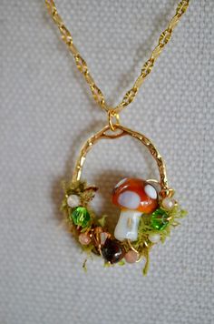 This stunning gold filled necklace features a unique pendant wrapped with preserved moss and accented with beautiful tiger's eye and moonstone. A dreamy mushroom sits elegantly on the pendant, adding a touch of whimsy to this nature-inspired piece. Perfect for nature lovers and those who appreciate one-of-a-kind jewelry, this necklace is sure to make a statement wherever you go. Handcrafted with love and attention to detail, this necklace is a truly special piece that will be treasured for years Brown Mushroom Necklace, Moss Necklace, Preserved Moss, Green Necklace, Unique Pendant, Green Aventurine, Tiger Eye, Moonstone, Gold Filled