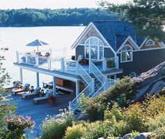 a house on the water with a dock in front of it