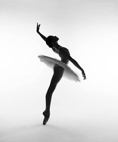 a black and white photo of a ballerina