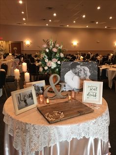 the table is set up with pictures and candles