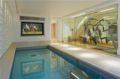 an indoor swimming pool with exercise equipment in it