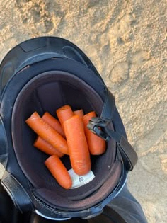 there are carrots that have been placed in the pocket of a motorcycle seat bag