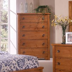 a bedroom scene with focus on the dresser and bed