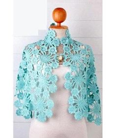 a white mannequin with a blue crochet jacket on top of it