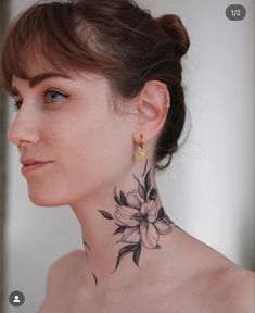 a woman with a flower tattoo on her neck