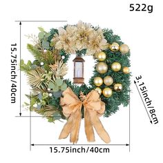 a christmas wreath with gold ornaments and a lantern hanging on the front door for decoration