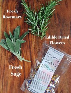 the ingredients to make an edible flower blend on a wooden table with rosemary, fresh rosemary, and edible dried flowers