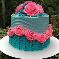 a blue and pink cake sitting on top of a white plate