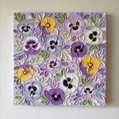 a purple and yellow flowered painting on a wall