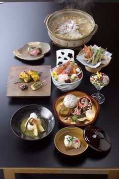 a table topped with lots of different types of food and dishes on top of it