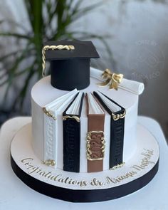 a cake decorated with books and graduation caps