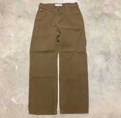 a pair of brown pants sitting on top of a floor