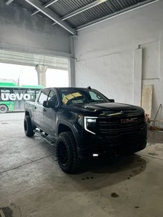 a black truck is parked in a garage