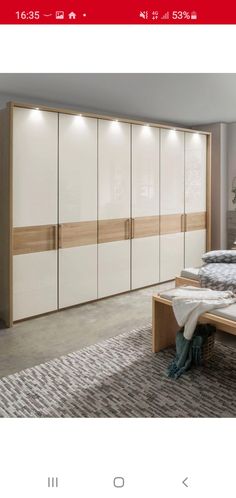 a bedroom with white and wood furniture in it