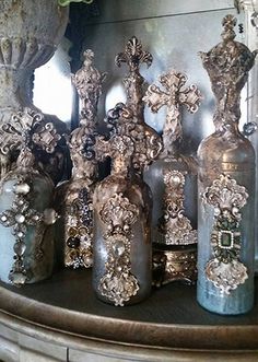 an assortment of decorative vases are on display in front of a mirror with flowers