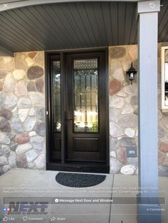 the front door to a home with stone walls