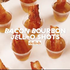 bacon bourbon jell - o shots are arranged in small cups with the words delish above them