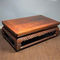 a wooden table sitting on top of a hard wood floor