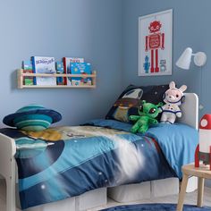 a child's bedroom with blue walls and furniture