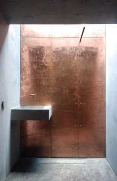 a bathroom with a metal wall and sink