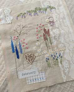 an embroidered piece with flowers on it and the words jennypaddon written in white